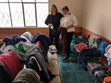 Dina and Mague providing clothing to patients at Atahualpa school at Chaupiloma - June 3, 2023