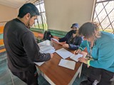 Luis, Mague and Nancy registering patients at Atahualpa school
 at Chaupiloma - June 3, 2023